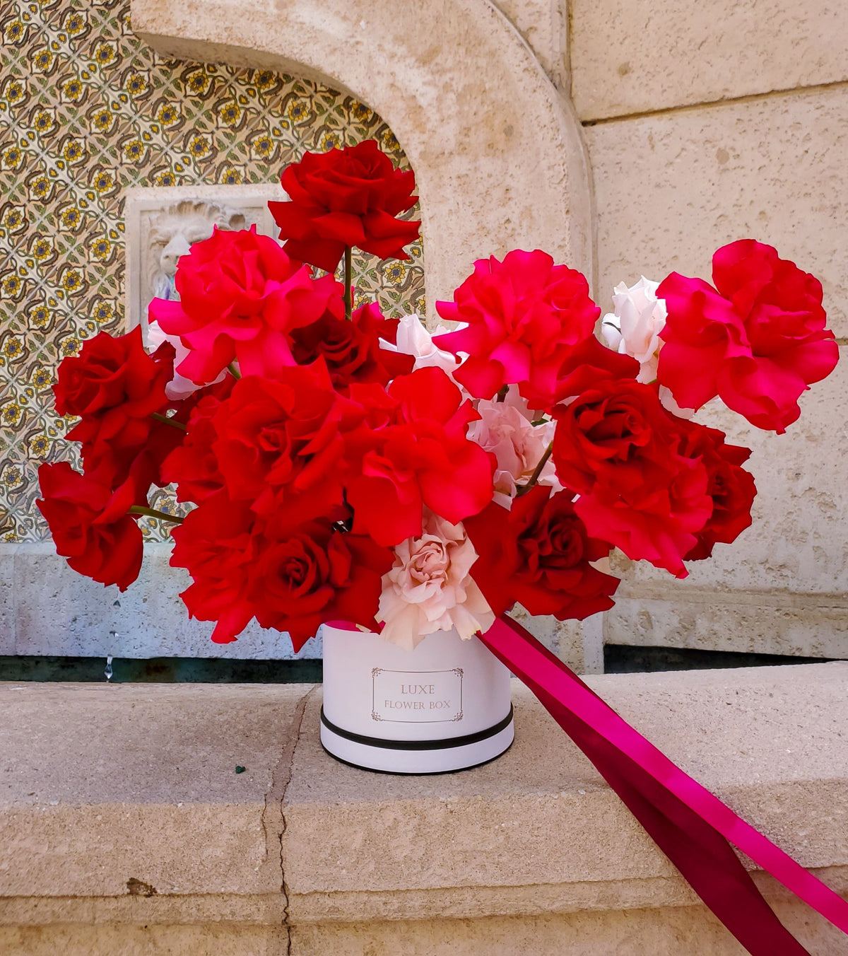 Elegant Valentine's Day arrangement featuring lush red roses beautifully arranged in a glass vase, creating a classic and romantic display.