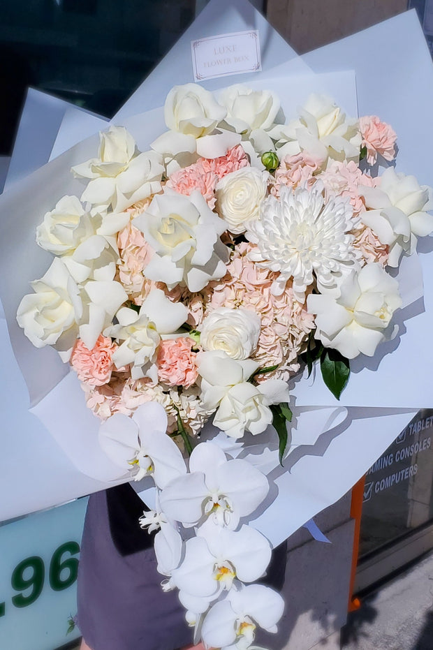 "Elegance in Bloom" arrangement White roses, orchid, ranunculus, hydrangea