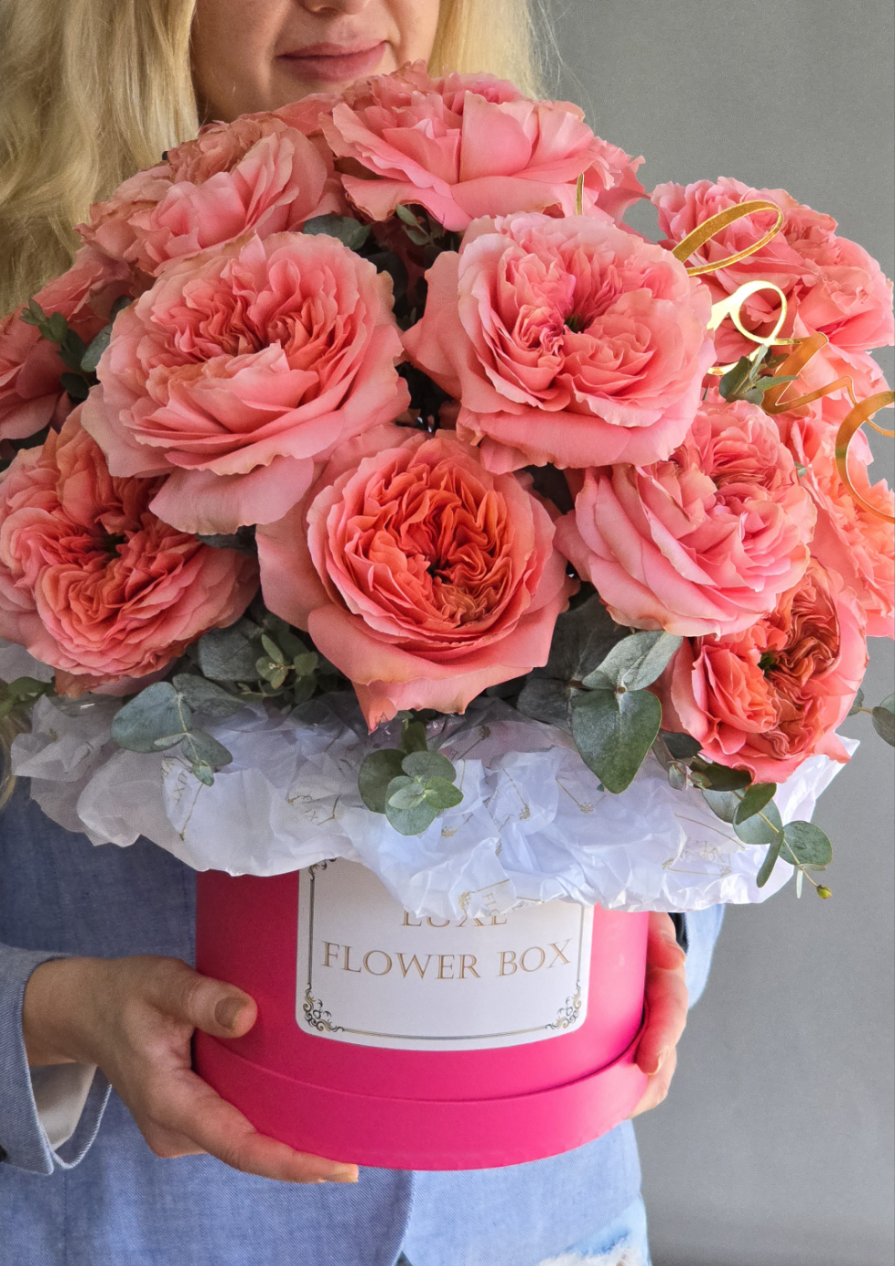 A stunning flower box filled with vibrant pink roses, elegantly arranged to convey love, admiration, and heartfelt emotions, perfect for celebrating special moments or expressing affection.