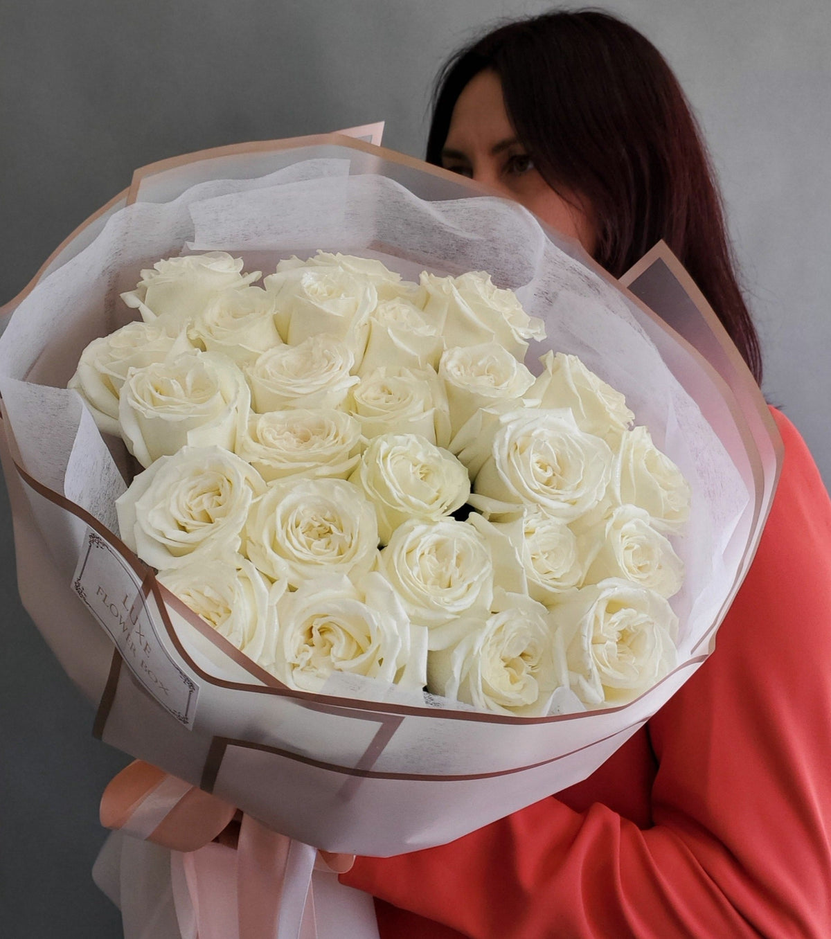 Close-up of pristine white roses in full bloom, arranged elegantly against the backdrop of Playa Blanca's serene coastal ambiance, evoking a sense of purity and tranquility.