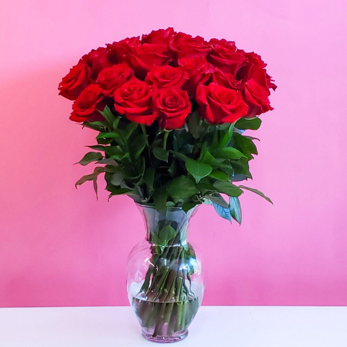 Arrangement of roses with greenery in an elegant vase