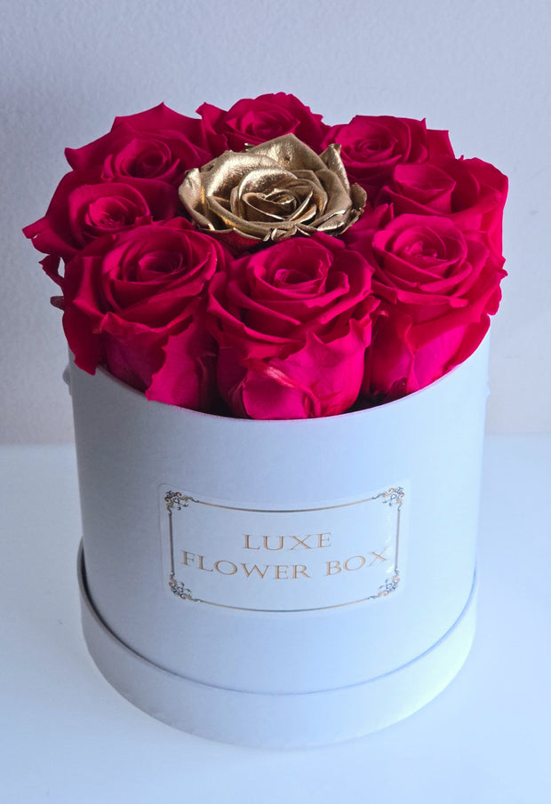 Small Strawberry Margarita box with vibrant hot pink roses and a luxurious gold rose centerpiece. A perfect elegant gift for any occasion.