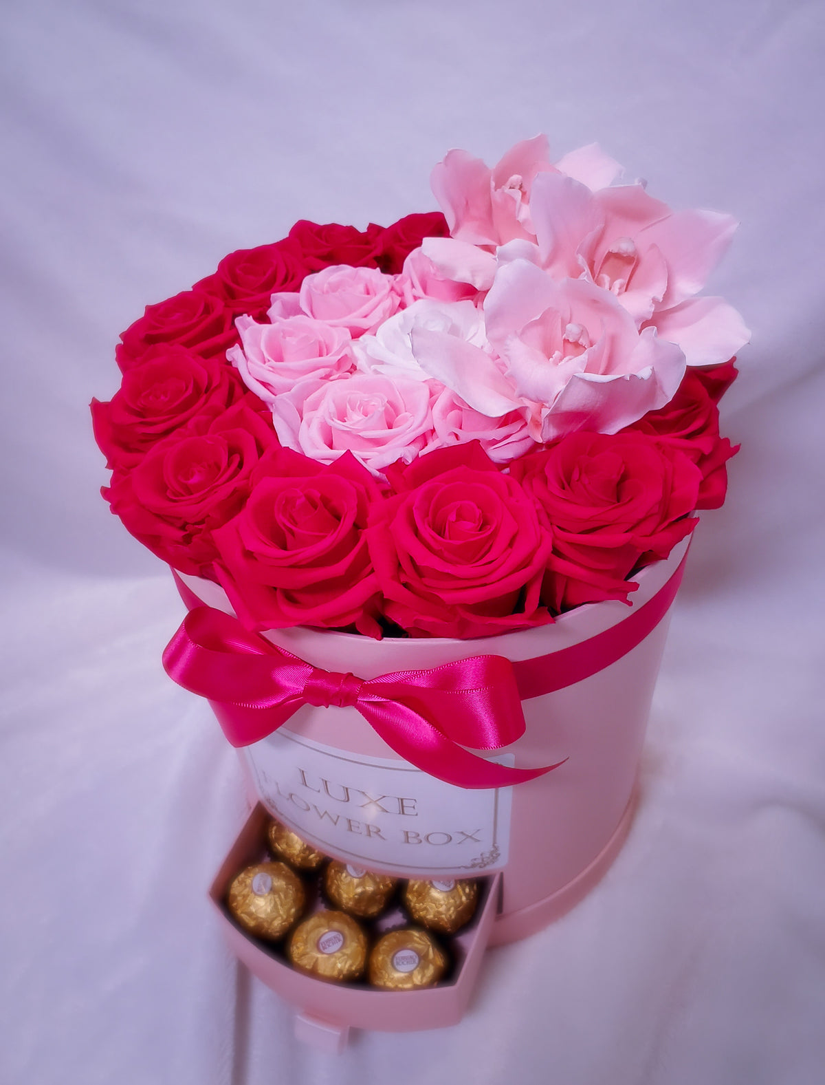 <transcy>Caja redonda grande con cajones-Trío de colores rosados ​​con orquídeas rosadas- Duran más de 1 año</transcy>